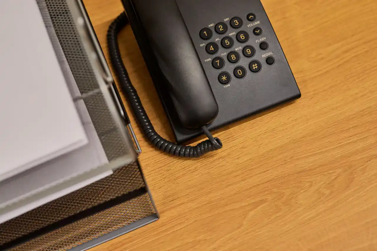 Organized office desk with a telephone ready for direct project enquiries